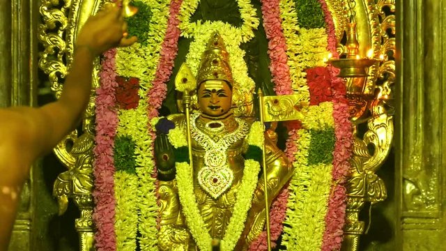 Hindu people making Puja to pray for God at Murugan Temple