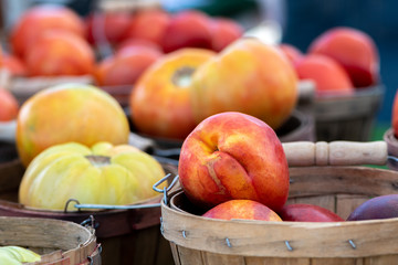 Displays of fresh fruits and vegetables for sale at a local farmers market