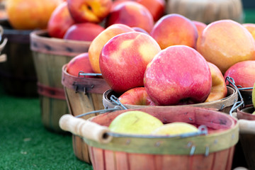 Wooden baskets of fresh apples for sale at a local farmers market
