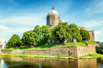 The historic fortress of the old city in Vyborg under reconstruction on the water. Bright sunny day. Beautiful landscape.