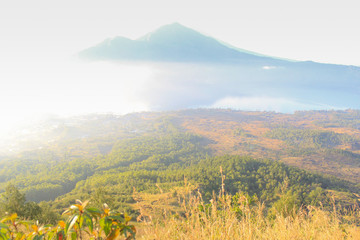 Fototapeta premium beautiful sunrise with fog and landscape view with Batur Mountain Background, Kintamani, Bali, Indonesia
