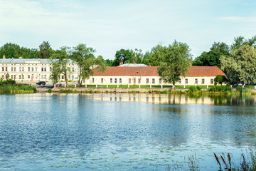 Obraz premium Beautiful historic buildings by the river in Vyborg on a bright sunny day.