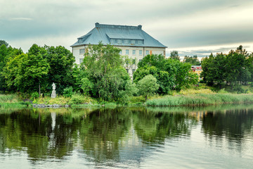 Large beautiful historic mansion in a park by the river. Beautiful landscape.