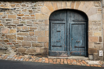 old gray door with a pointy top