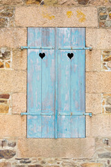 Old blue door with heart-shaped holes