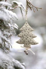 Christmas and New Year winter festive background.White Christmas decorative tree on a snow thuja...