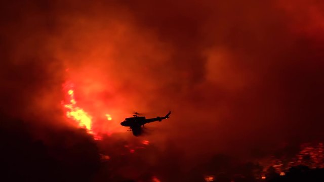 2019 - a helicopter makes a dramatic water drop at night responding to the Cave Fire near Santa Barbara, California.