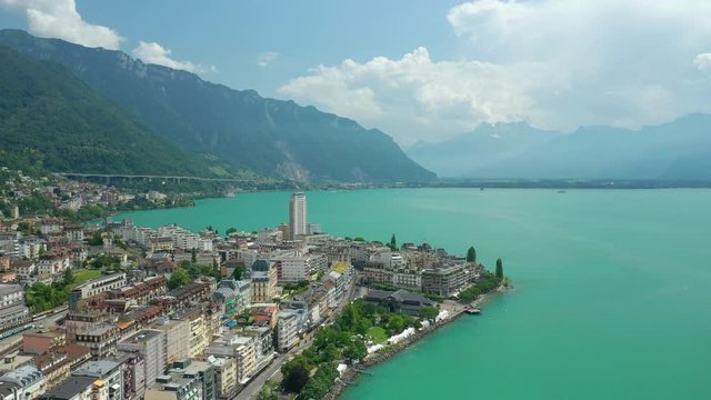day time flight over montreux city center geneva lake famous bay aerial panorama 4k switzerland