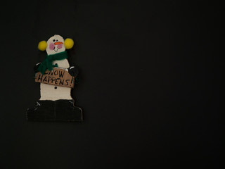 Wooden Snowman Ornament on Black Background