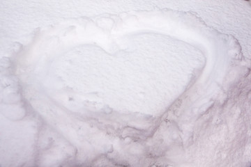 The symbol of the heart, painted on the fresh white snow