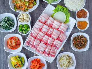 Set of raw fresh pork slide in white plate serve with many kind of vegetable.