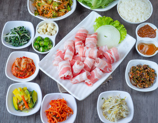 Set of raw fresh pork slide in white plate serve with many kind of vegetable.