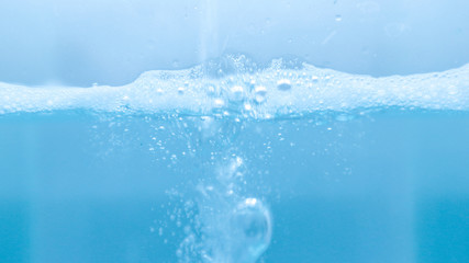 Water and soap bubbles on the water surface, water waves, blue water  