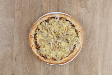 Hawaiian pizza pizza close up on a wooden background - pineapple