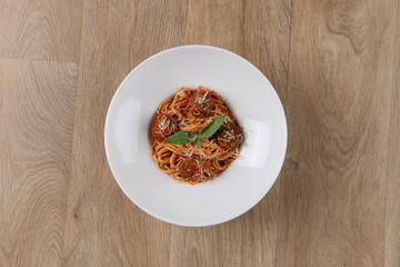 gourmet spaghetti and meatballs - pasta on white plate - wooden background - isolated