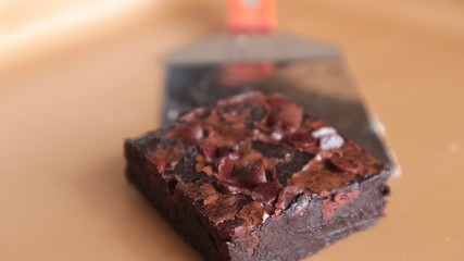 Chocolate brownies placed on a baking tray are beautifully arranged.