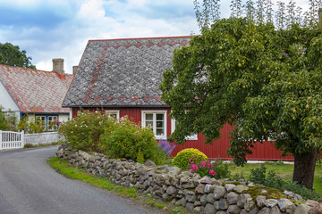 View into a street with small country houses and orchards