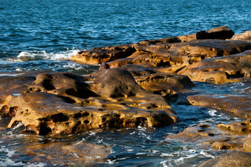 Sydney Australia, gentle waves breaking over rocks in Sydney Harbour