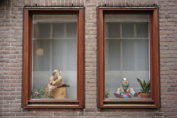 two windows decorated with flowers and sculptures