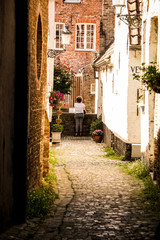 Fototapeta na wymiar Small and calm street with a view in Bruges, Belgium