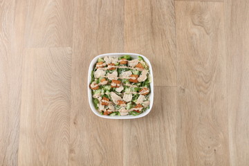 Greece salad with fresh vegetables in a withe bowel  on a wooden background