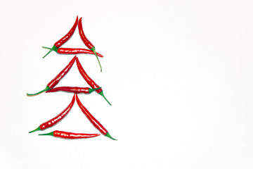 abstract christmas tree composed of chilli peppers  on red background