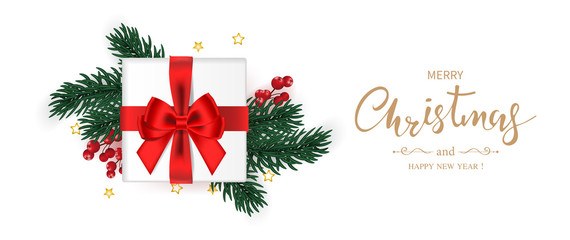 Fototapeta na wymiar Merry Christmas and Happy new year banner. Gift box decorated with red bow, green pine branches,holly berry and star on white background. Vector illustration.