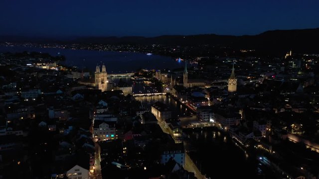 night illuminated flight over zurich city central district aerial panorama 4k switzerland
