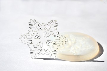 Transparent epoxy resin snowflake. White silicone mold isolated on white background. Handmade...