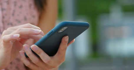 Close up of woman use of mobile phone at outdoor