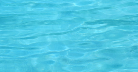 Fototapeta na wymiar Blue water wave in swimming pool