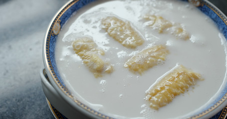 Cook coconut banana dessert in kitchen