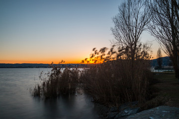 Fototapeta na wymiar Lungolago al tramonto, Lago Maggiore, Angera, Varese, Lombardia, Italia