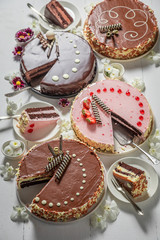 Sweet cakes on table decorated with flowers