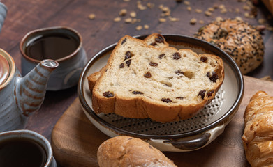 bread and Black Coffee on wood table.