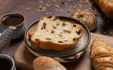 Naklejka premium Fresh bread and Black Coffee on wood table.