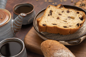Fresh bread and Black Coffee on wood table.
