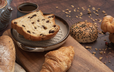 bread and Black Coffee on wood table.