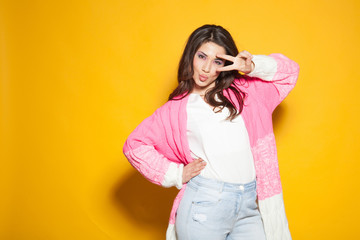 the girl in the pink jacket shows two fingers