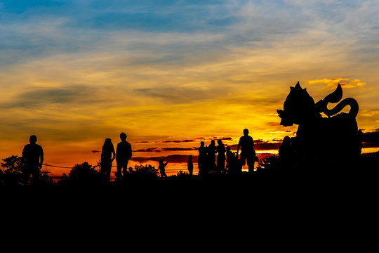 Silhouette Image of The statue of golden lion on a field with blue sky background at sunset or evening time, at Singha park Chiangrai Thailand.