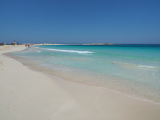 Marsa Matruh, Egypt. The sandy beach and the amazing sea with tropical blue, turquoise and green colors. Relaxing context. Fabulous holidays. Mediterranean Sea. North Africa. Clean and pristine sea