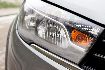 headlight of a modern car in gold color