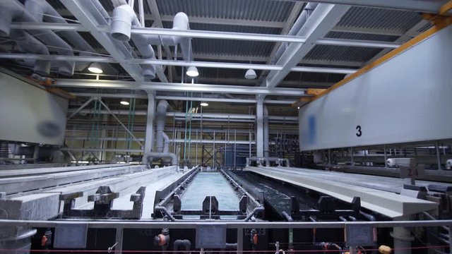 Process of anodizing aluminum plates in production, Immersion of aluminum plates in liquid. Automatic production line in modern manufacture. .