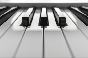 Close up detail on the black and white keys of a music keyboard, with copy space for text