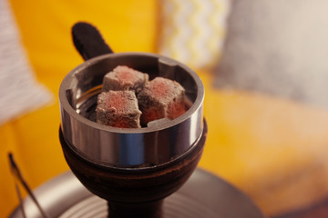 Recreation and entertainment. Hookah, coals and smoke in a relaxing environment