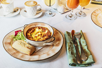 Baked omelet for breakfast with cutlery on the table. Livestyle.