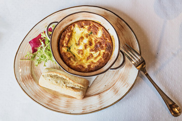 Baked omelet for breakfast with cutlery on the table. Livestyle.