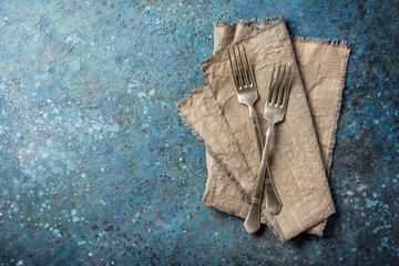 Two vintage silver fork on linen napkin
