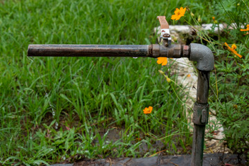 dripping water from pipe in an Argricultural field from open tap