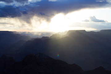 Grand Canyon National Park. Incredibly beautiful sunny sunset. The sky with a huge cloud, a mountain range. Colorful landscape. Mountains , layout for design. Clouds in trendy classic blue color 2020.